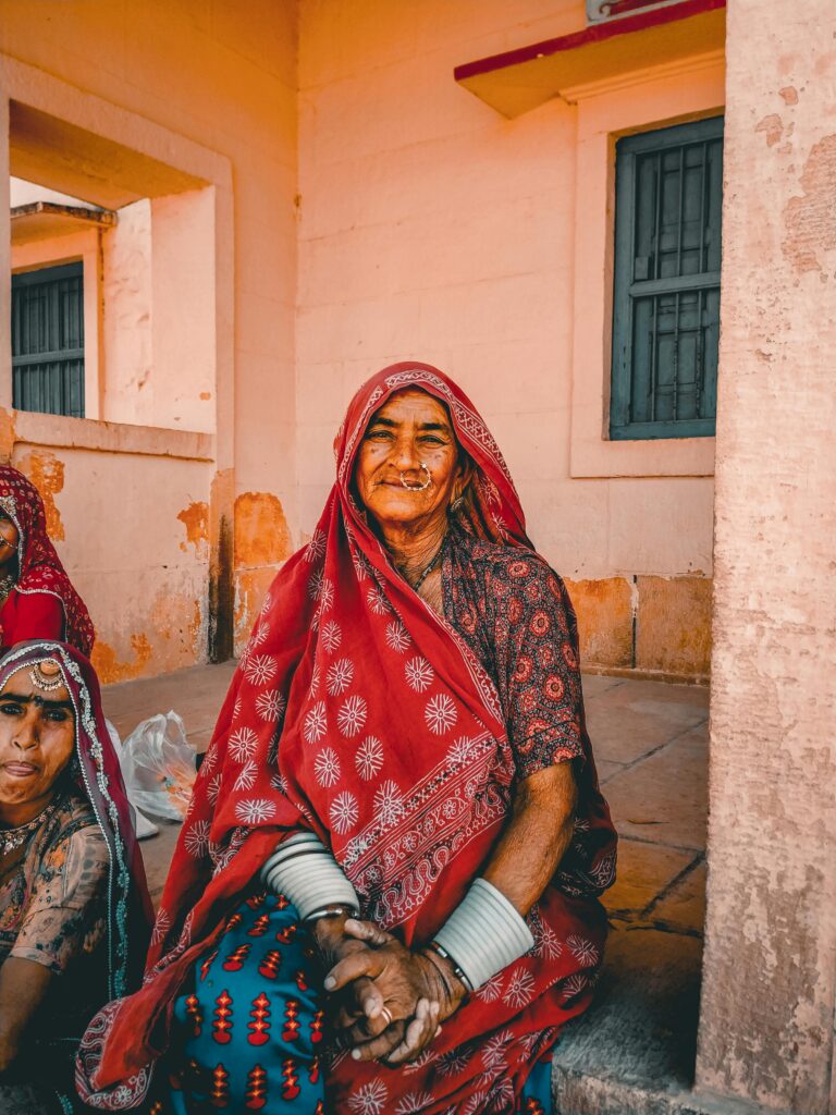 Old Indian woman with girl sitting on terrace